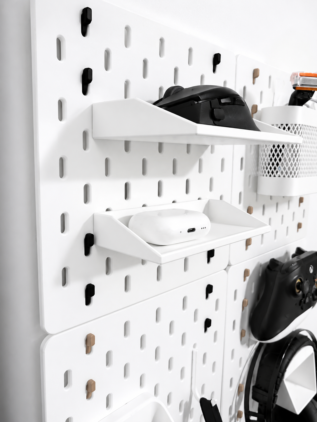 IKEA SKÅDIS shelf mounted on pegboard for gaming setup storage, desk accessories, and workspace organization
